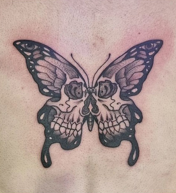 Fine line butterfly tattoo on the sternum