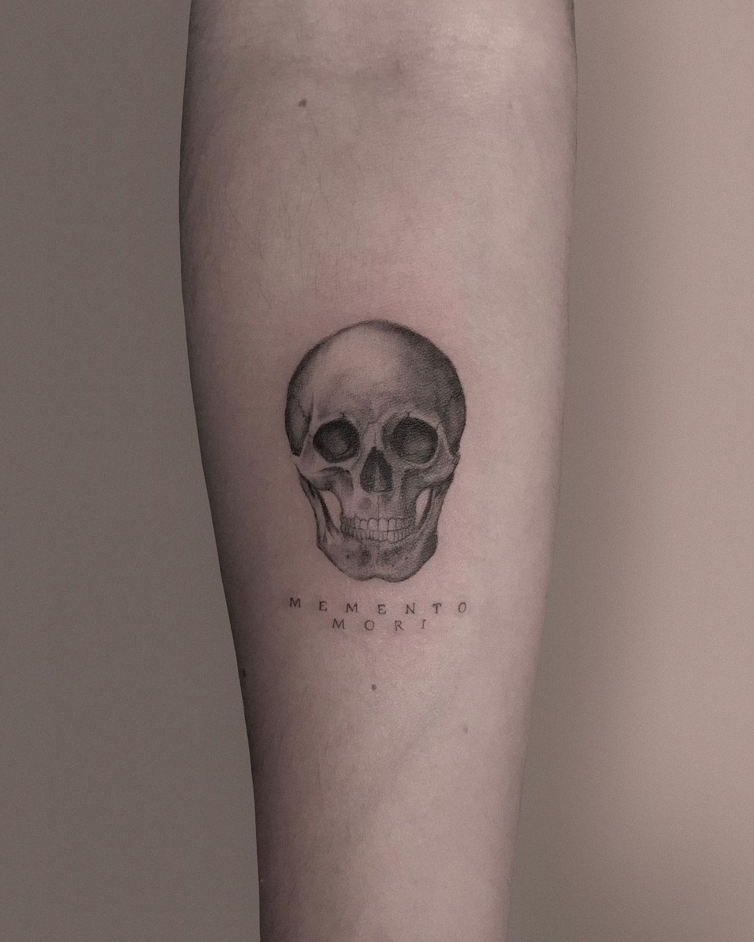 Haunting Reality Memento Mori Skull Forearm Tattoo