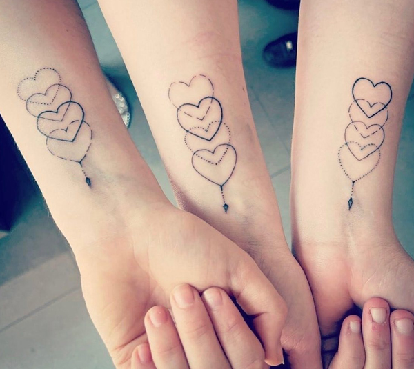 Sibling Tattoos With Interlapping Hearts