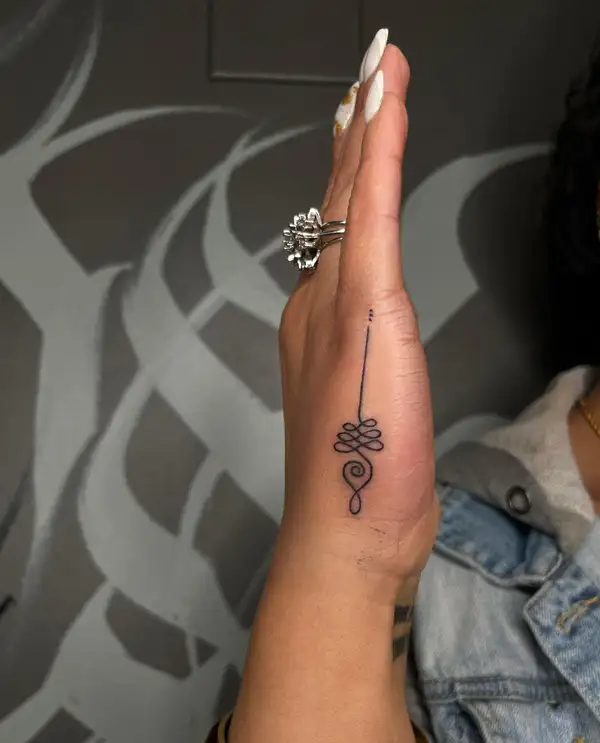 Fine line lotus unalome tattoo located on the sternum