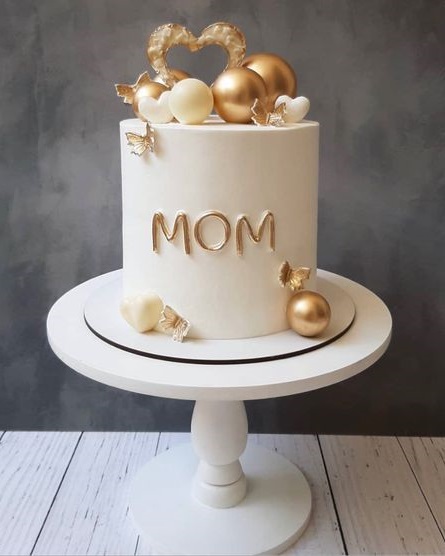 Modern Elegant Birthday Cake With Melted White Chocolate, Golden Heart And  Chocolate Balls, Macaroons, Meringue And Caramel. Stock Photo, Picture and  Royalty Free Image. Image 149999829.