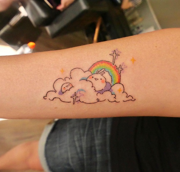 Adorable Rainbow In Clouds Tattoo