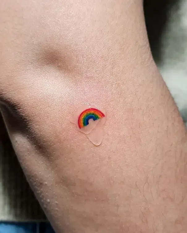 Minimalistic micro rainbow tattoo done on the wrist