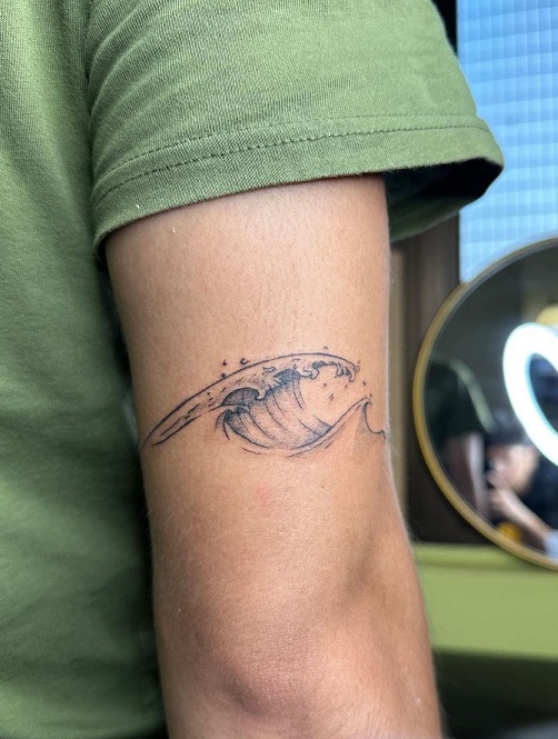 Realistic Wave Tattoo Near The Elbow