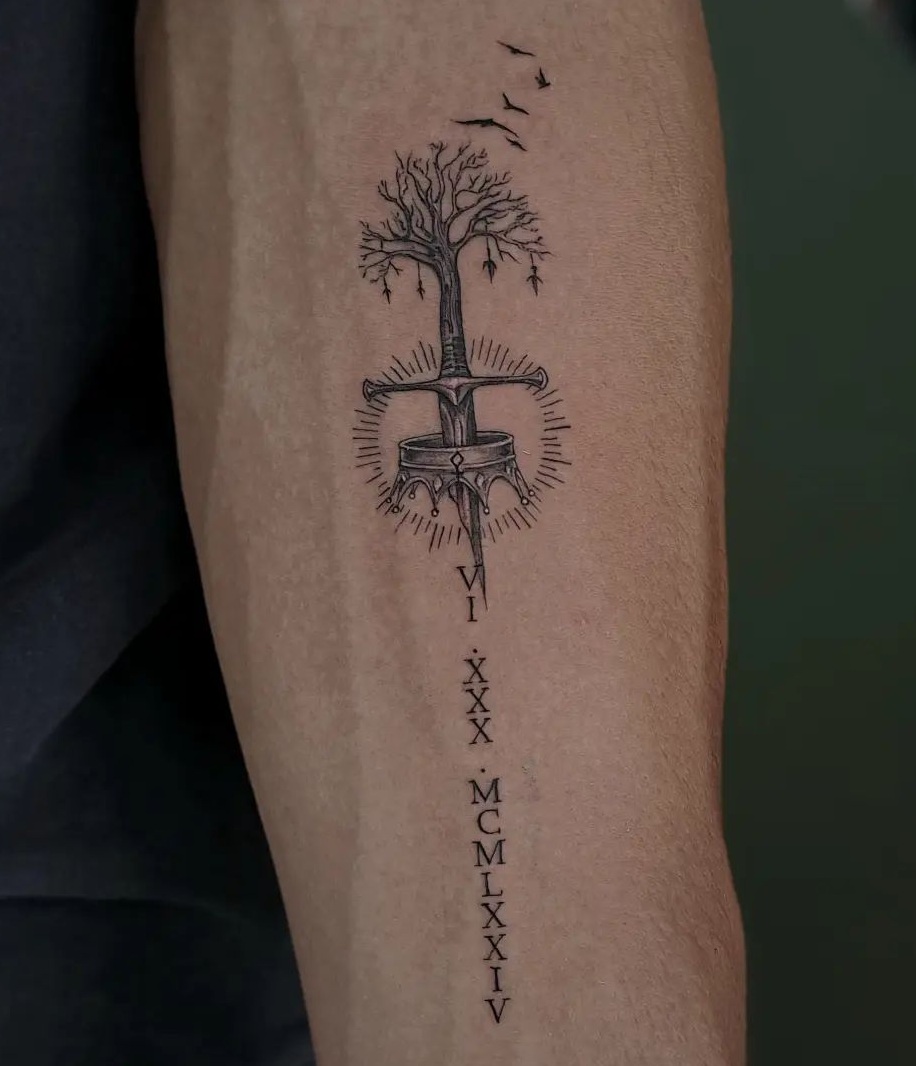Sword And Crown Tattoo On The Forearm