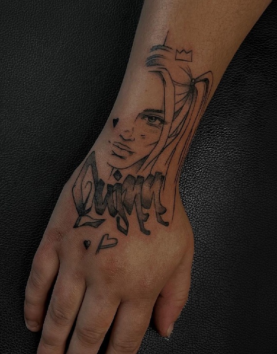 Black And Grey Harley Quinn Tattoo On The Wrist