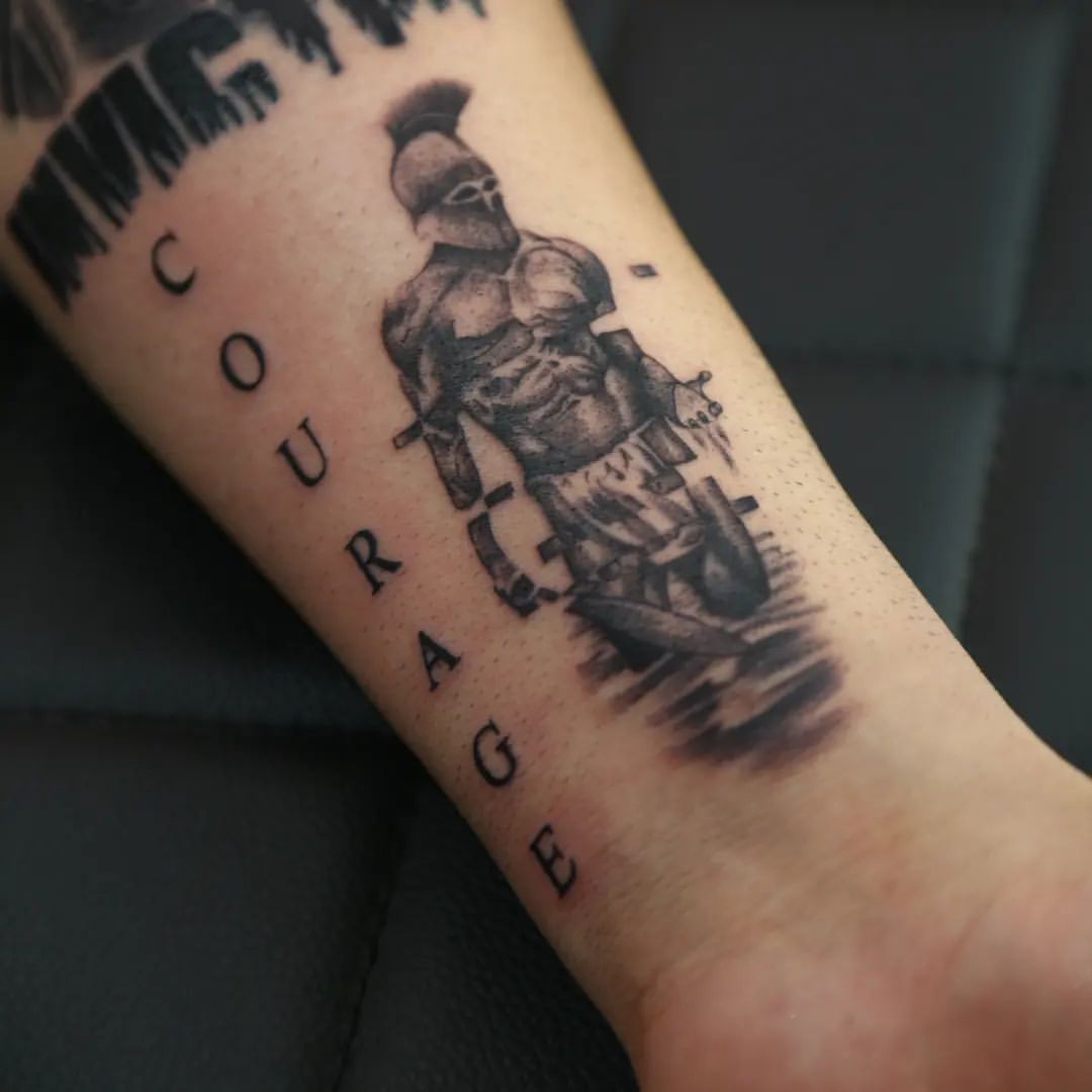 Forearm Spartan Tattoo With The Words Courage