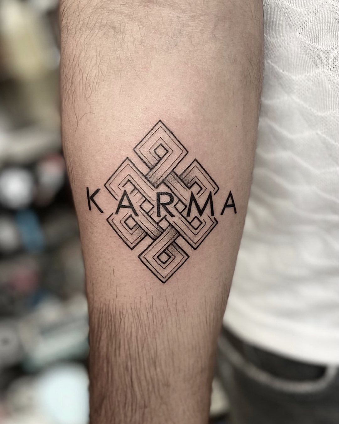 Bold Geometric Karma Symbol Tattoo Design