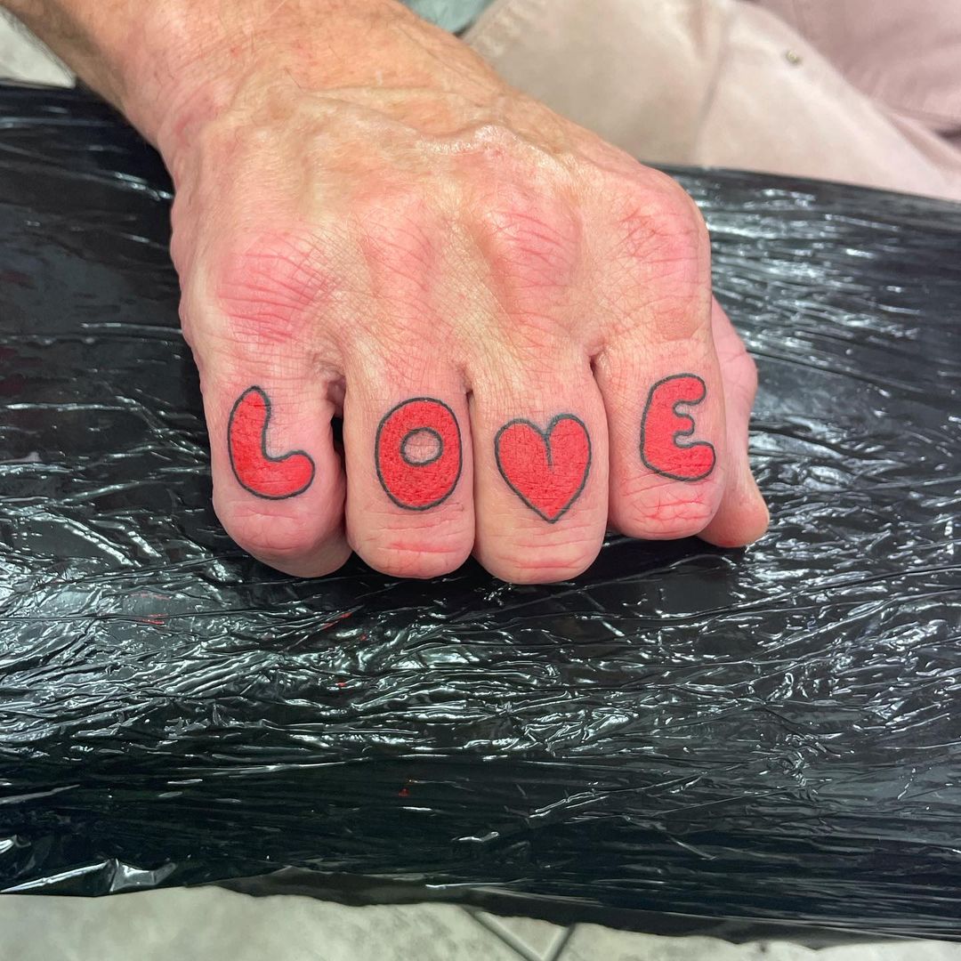 'love' In Striking Red Knuckle Tattoos
