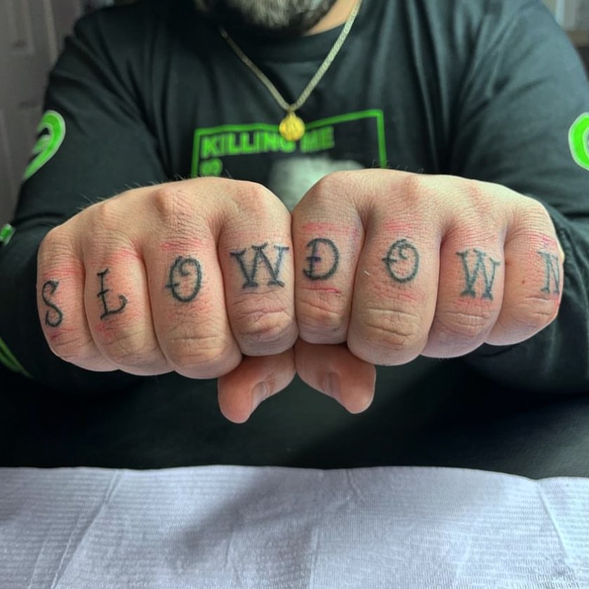 'slow Down' Reminder Knuckle Tattoos