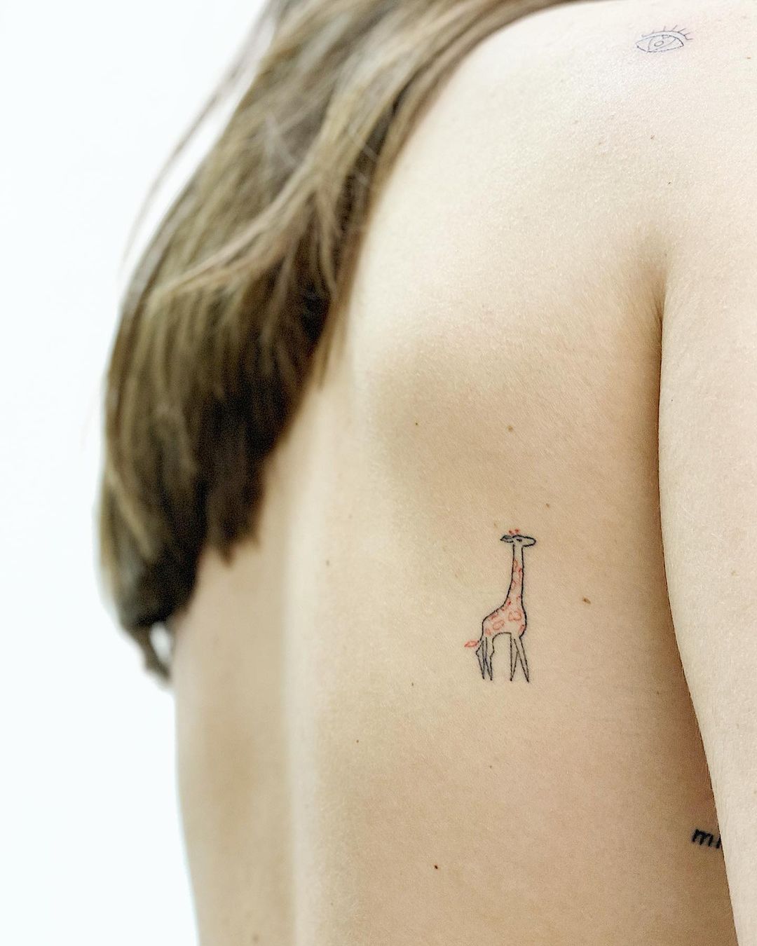 Tiny Giraffe Rib Tattoo