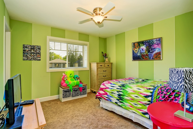 Adorable,kids,room,in,green,color,with,bright,colorful,bedding