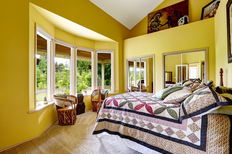 Luxury,bedroom,interior,in,bright,yellow,color,with,high,and